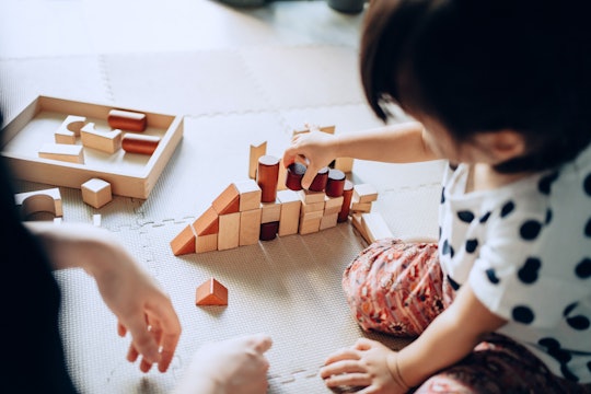 kid playing with montessori toy