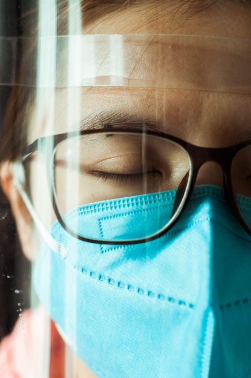 A woman wears an n95 mask and face shield to cope with coronaphobia, or extreme anxiety about corona...