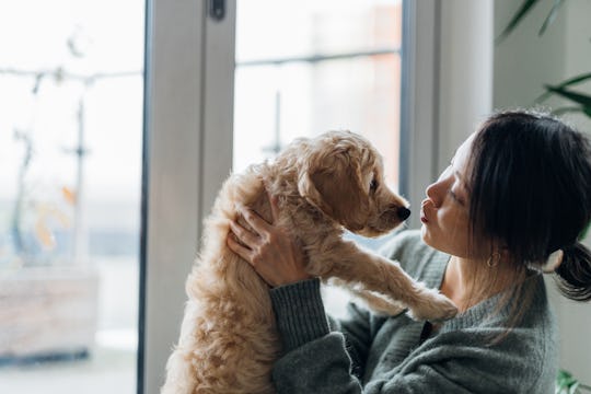 woman snuggling dog