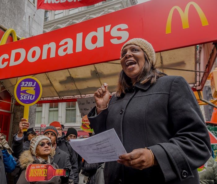 An activist is seen speaking at a Fight For $15 protest in winter.