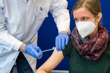 A woman with a face mask getting a COVID vaccine on Campus