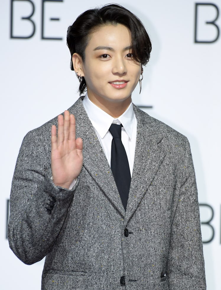 Jungkook waves to fans.