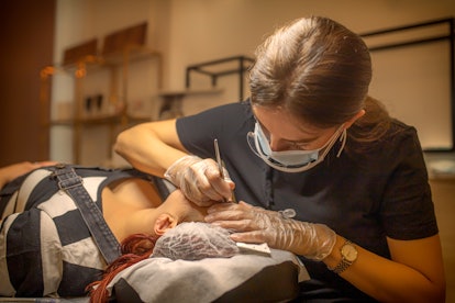 woman getting her eyebrows microbladed