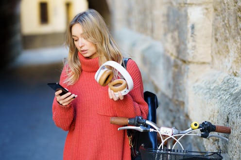 woman, texting, headphones, bike 