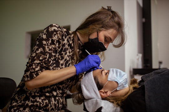 woman getting her eyebrows microbladed