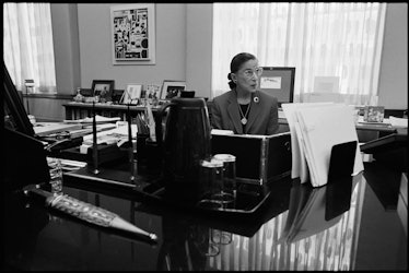 Ruth Bader Ginsburg sits at her desk and shares strong women quotes, which you can use for Instagram...
