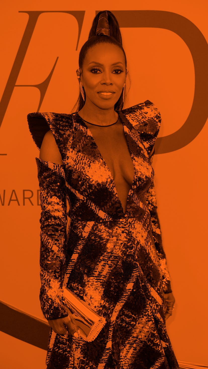 June Ambrose in a black sequinned dress with a high ponytail and large earrings