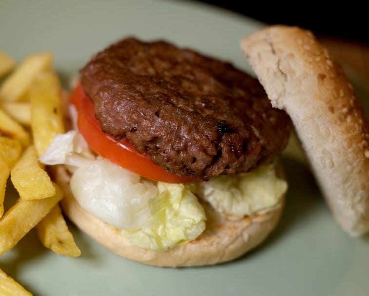 A plant-based burger by Beyond Meat is seen on a plate. 