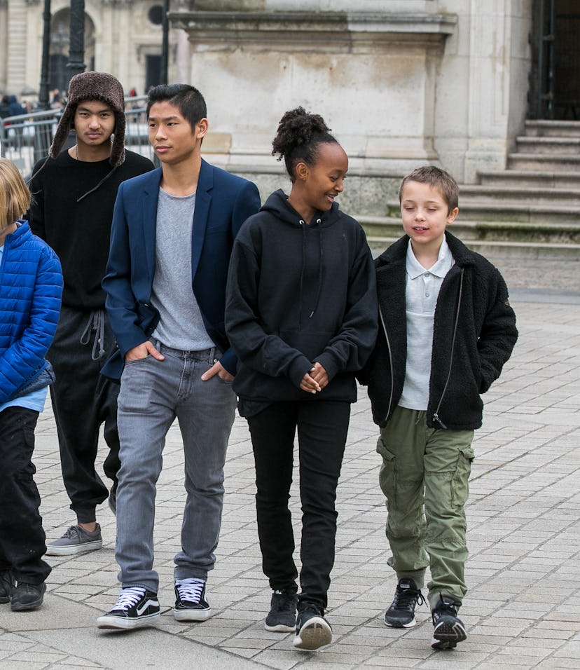 Angelina Jolie walks outside with her six children.