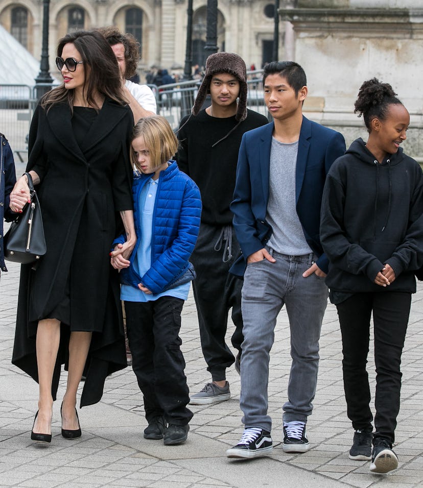 Angelina Jolie walks outside with her six children. 