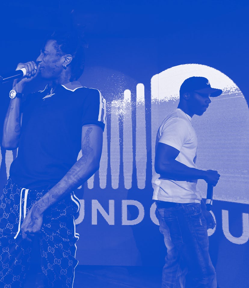 Two musicians performing on a stage, in front of a SoundCloud logo. 