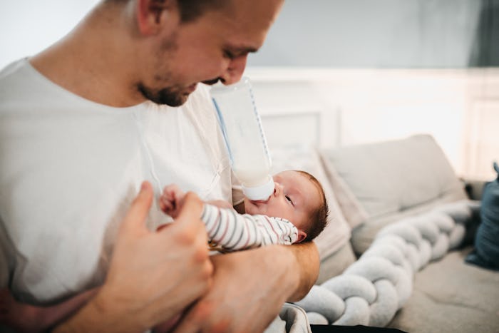 dad rocking baby in his arms