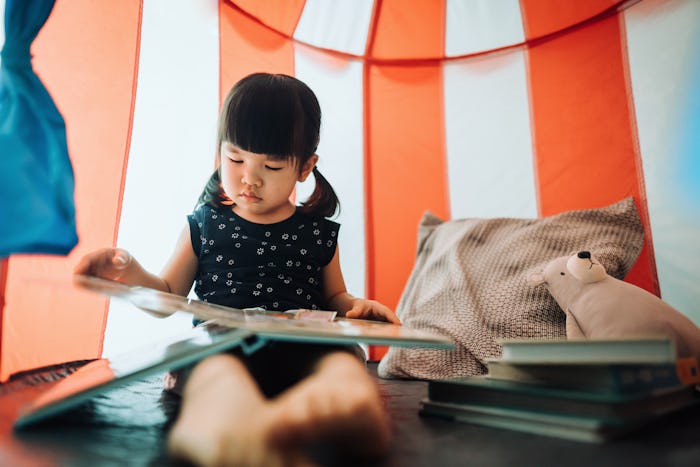 little girl reading books