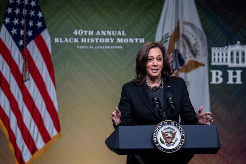 kamala harris speaks at a podium, in a story about Women's History Month facts