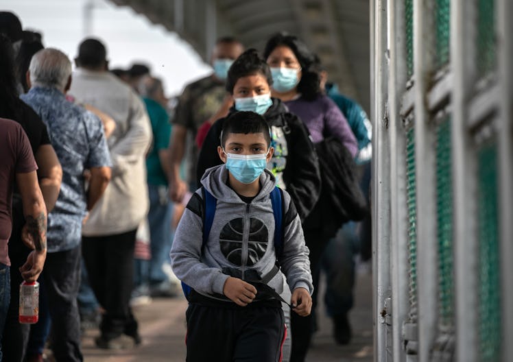 MATAMOROS, MEXICO - FEBRUARY 25: Deportees walk across a U.S.-Mexico border bridge from Texas into M...