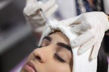 VALENCIA, VENEZUELA - JUN 22: An aesthetic doctor gives woman patient a botox injection, on June 22,...