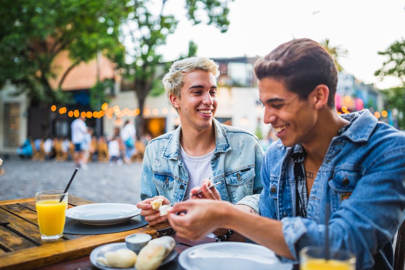 Young gay couple in a street restaurant. Having a good time. Palermo Soho, Buenos Aires, Argentina