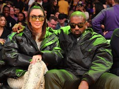 LOS ANGELES, CALIFORNIA - JANUARY 13: Kim Kardashian and Kanye West attend a basketball game between...