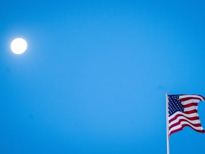03 November 2020, Berlin: The flag of the United States of America is waving in the wind at the US e...