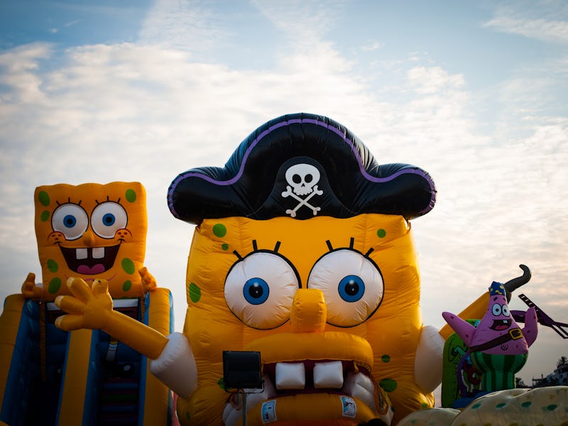 A person is seen wearing a SpongeBob costume with a pirate hat on.