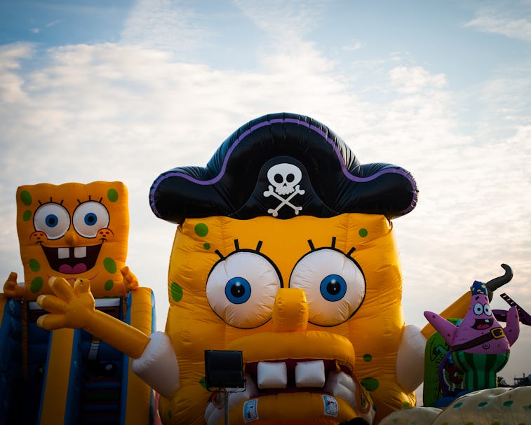 A person is seen wearing a SpongeBob costume with a pirate hat on.