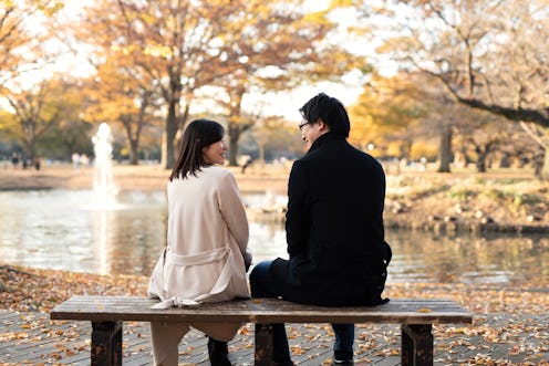 Asian mid-adult couple dating in Autumn park of Tokyo, Japan