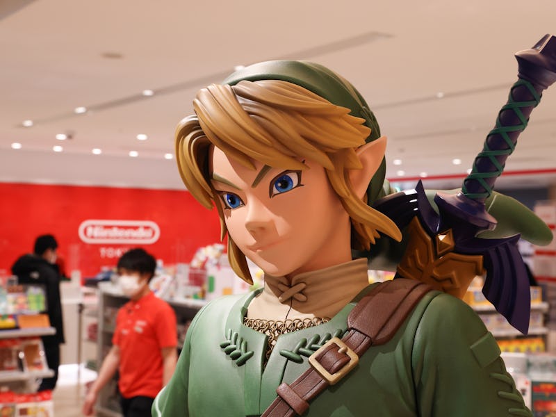 Link figurine from Legend of Zelda with shop staff inside Nintendo Tokyo store in Shibuya. (Photo by...