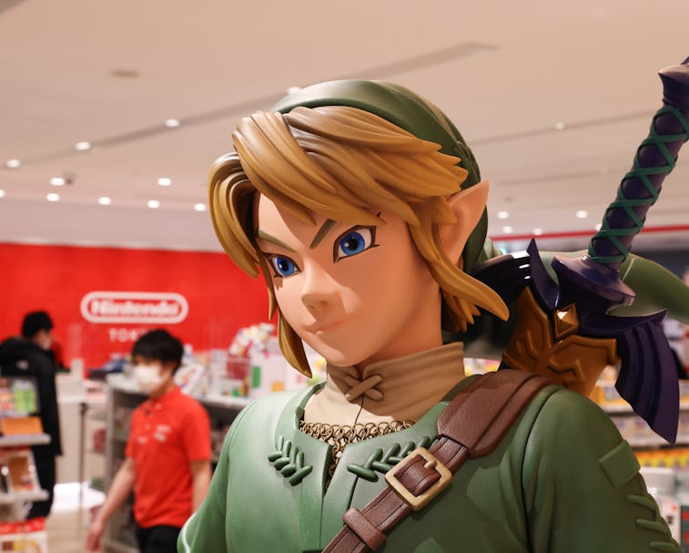 Link figurine from Legend of Zelda with shop staff inside Nintendo Tokyo store in Shibuya. (Photo by...