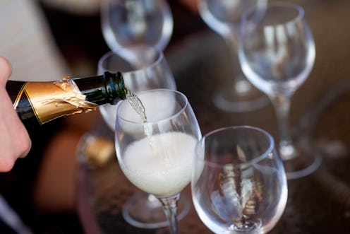 Champagne flutes being filled with champagne