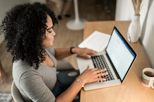 Young woman using laptop working at home