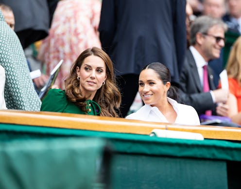 LONDON, ENGLAND - JULY 13: Catherine, Duchess of Cambridge talks with Meghan, Duchess of Sussex in t...