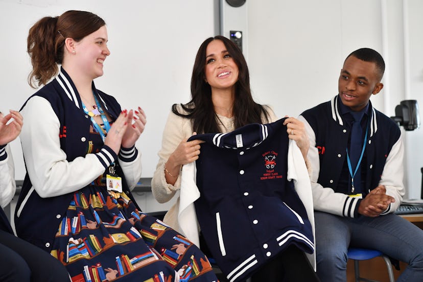 LONDON, ENGLAND - MARCH 06: Meghan, Duchess of Sussex smiles after being gifted a jacket from the 'S...