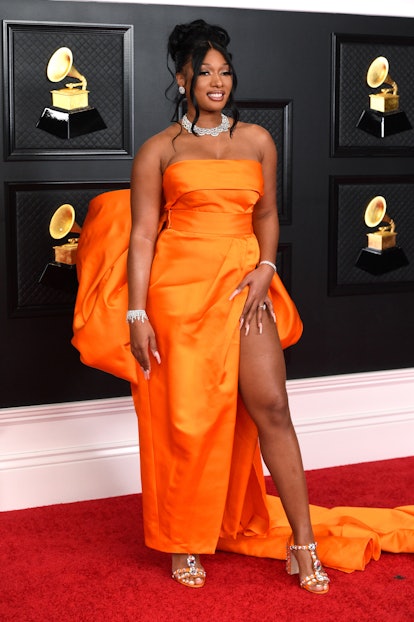 Megan Thee Stallion wearing an orange Dolce & Gabbana gown at the 2021 Grammys.