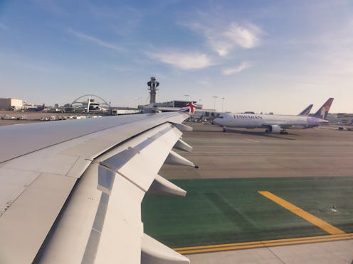 Los Angeles International Airport (LAX) in evening light - shot from a aircraft's window on take...