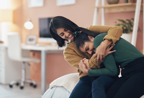 Shot of two happy young women sitting together at home post-COVID. Anxiety experts explain how to de...