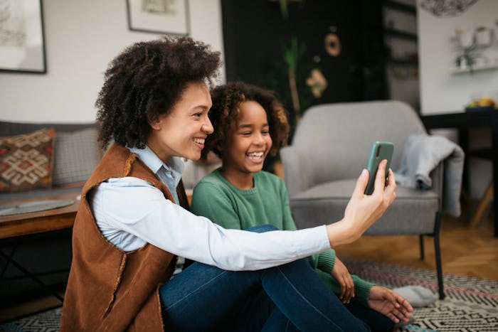 Happy African American family, single mother and her daughter at home, celebrating international wom...