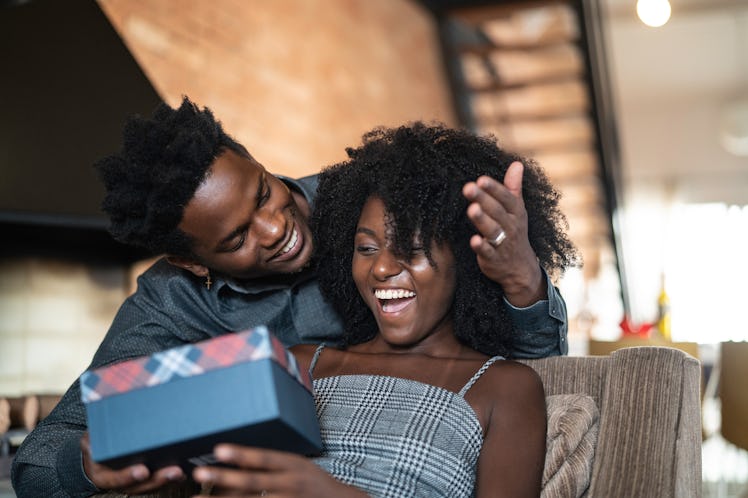 A man gives his joyful Taurus partner a gift that is thoughtful and bull of love. 