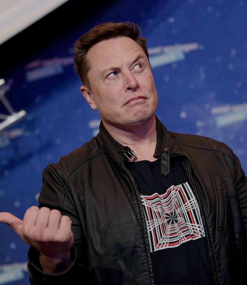 SpaceX owner and Tesla CEO Elon Musk (R) gestures as he arrives on the red carpet for the Axel Sprin...