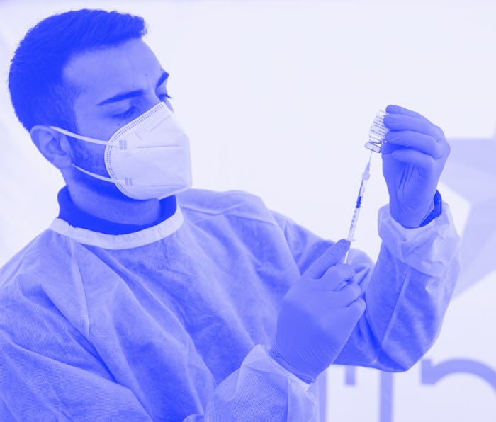 MILAN, ITALY - MARCH 15: A military nurse handles a vial of AstraZeneca Covid-19 vaccine at the larg...