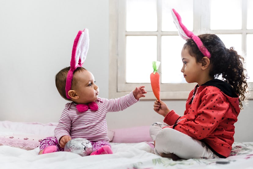 baby and kid with easter bunny ears, in an article about is the easter bunny real?