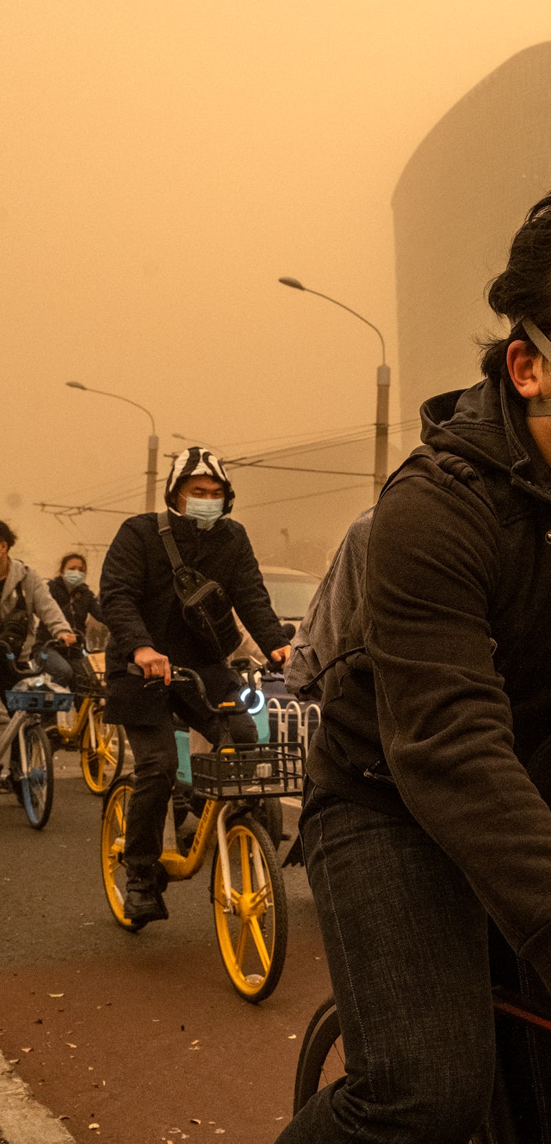 BEIJING, CHINA - MARCH 15: People wear protective masks as they commute during a sandstorm on March ...