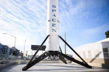 The recovered first stage of a Falcon 9 rocket stands at Space Exploration Technologies Corp. (Space...