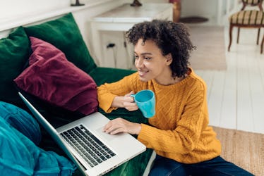 Young African-American woman working from her living room.