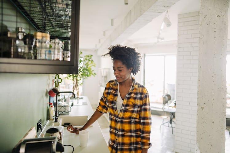 A woman makes coffee from a TikTok recipe in her apartment in the morning.