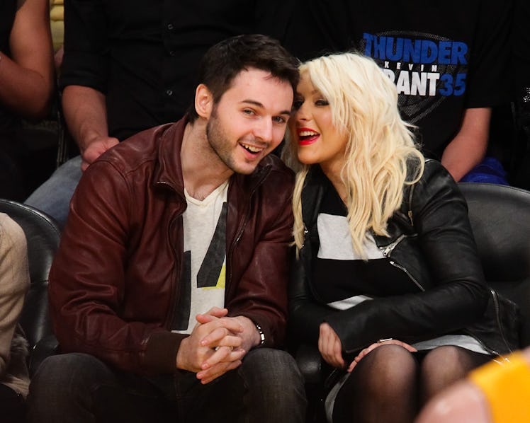 LOS ANGELES, CA - MARCH 29:  Matt Rutler (L) and Christina Aguilera attend a basketball game between...