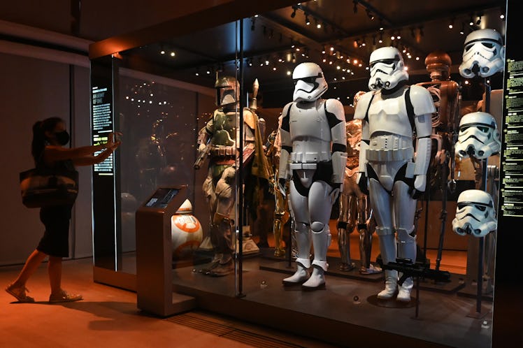 A visitor takes a photo of life-sized figures of stormtroopers from the Star Wars series displayed a...