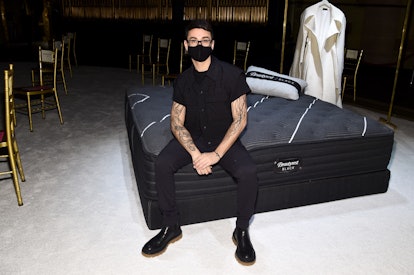 NEW YORK, NEW YORK - FEBRUARY 25: Christian Siriano poses with Beautyrest products on display during...