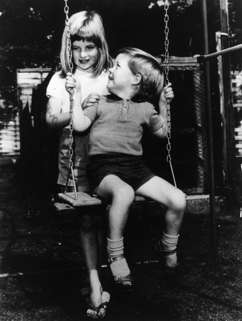 Diana Spencer pushes her brother on the swings.
