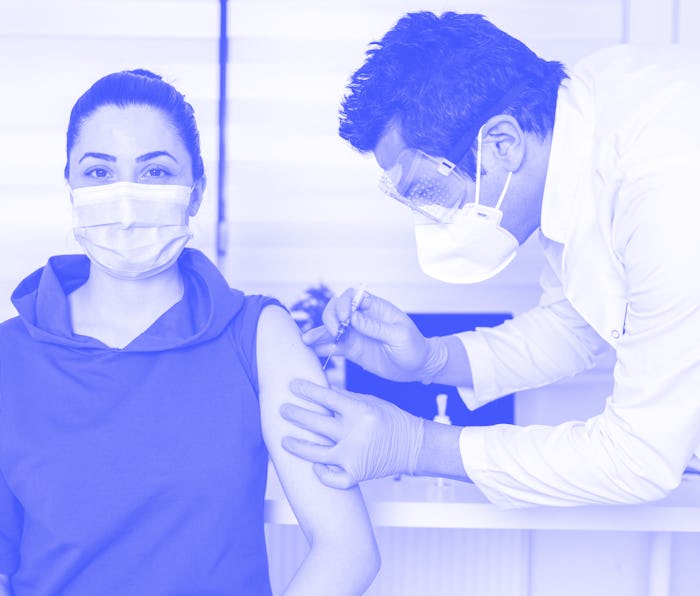 Young woman being vaccinate at doctor's office. Vaccination while a global pandemic
