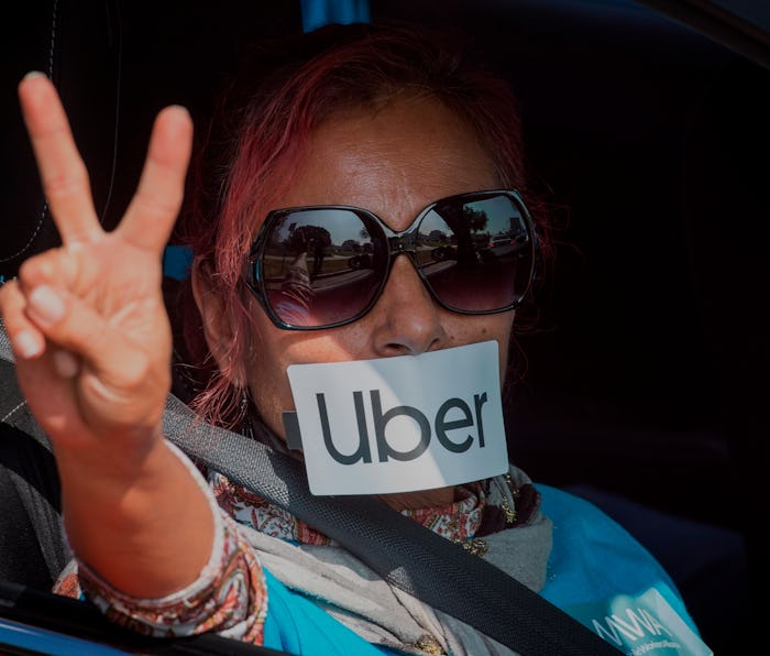 A protester gestures as Uber and Lyft drivers drive through Beverly Hills on their way to demonstrat...